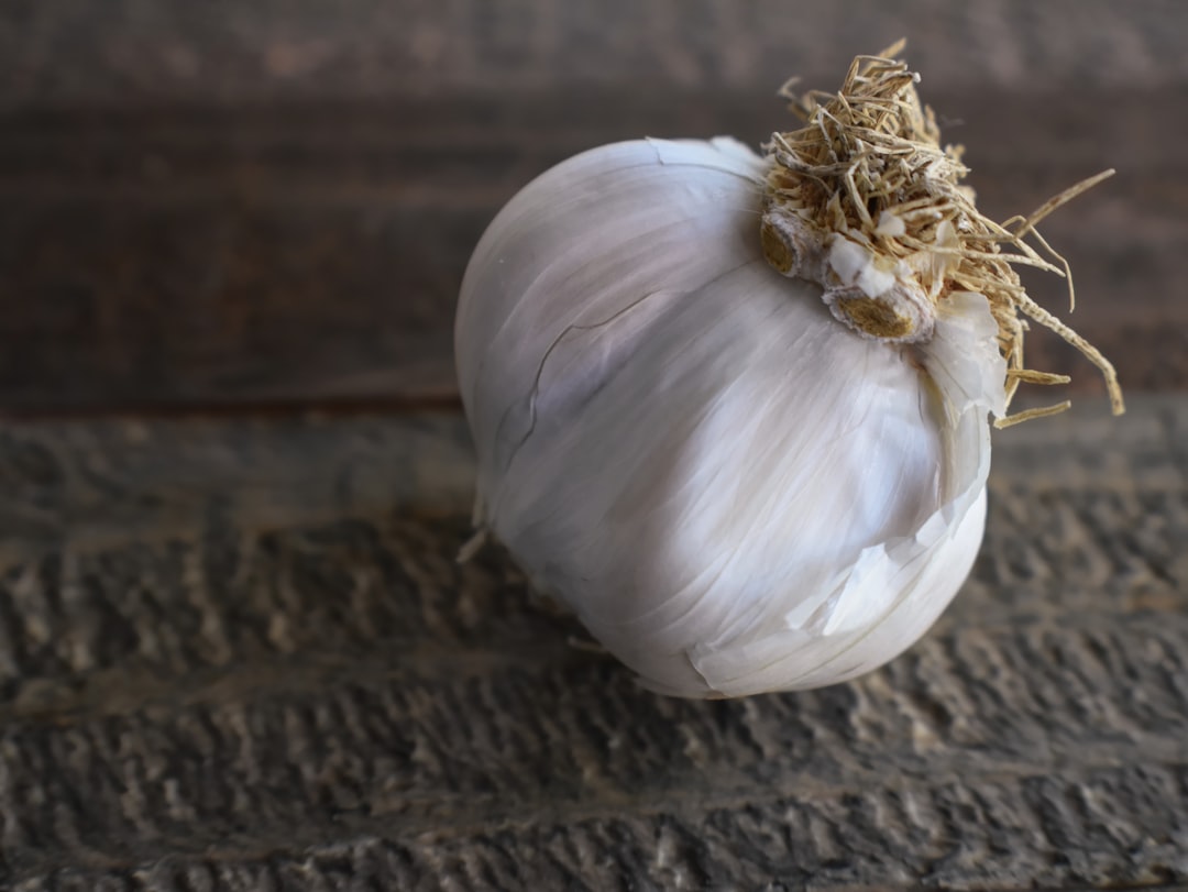 Photo by Ray Shrewsberry a close up of a garlic on a wooden surface